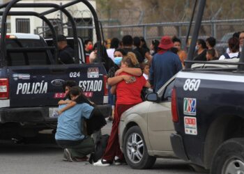 Familiares de internos se abrazan hoy afuera del Centro de Reinserción Social (Cereso) número 3, en Ciudad Juárez, estado de Chihuahua (México). EFE/Luis Torres