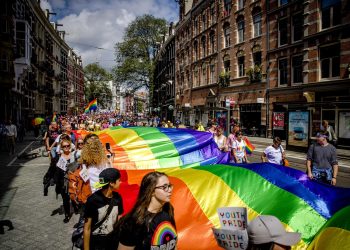 Miles de personas portan una bandera gigante del arcoíris mientras caminan en la Marcha del Orgullo Gay por el centro de Ámsterdam el 29 de julio de 2017. EFE