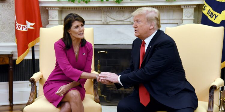 (FILES) In this file photo taken on October 09, 2018, US President Donald Trump shakes hands with US Ambassador to the UN, Nikki Haley, in the Oval office of the White House in Washington, DC. - Haley on February 1, 2023, previewed a "big announcement" she plans to make in two weeks, widely expected to be the launch of her 2024 US presidential run -- making her the first Republican to throw down the gauntlet to Donald Trump in the race for the White House.  "My family and I have a big announcement to share with you on February 15th! And yes, it's definitely going to be a Great Day in South Carolina!," she tweeted. (Photo by Olivier Douliery / AFP)