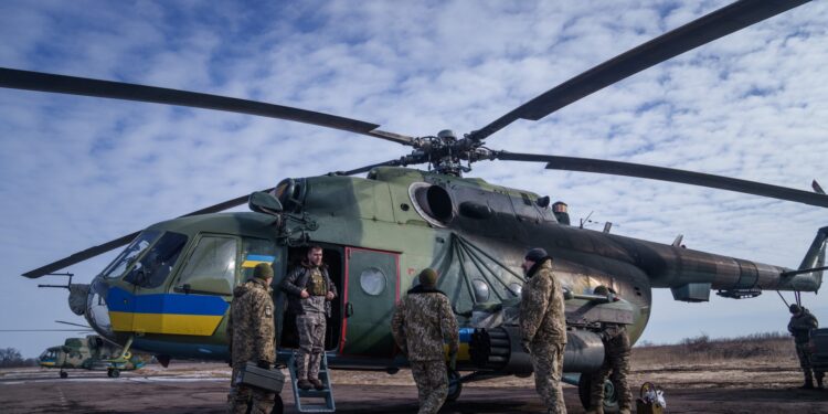 Helicopter crew members of the 18th Separate Army Aviation Brigade prepare before a take off, in eastern Ukraine on February 9, 2023, amid Russia's military invasion on Ukraine. (Photo by Ihor Tkachov / AFP)