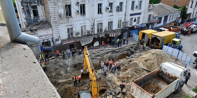 Communal employees work on a site of an overnight explosion in the centre of Kharkiv on June 6, 2023, following missile strike, amid the Russian invasion of Ukraine. (Photo by SERGEY BOBOK / AFP)