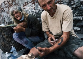 PHILADELPHIA, PENNSYLVANIA - JULY 19: Rich and Peg shoot-up a mix of heroin and fentanyl on a street in Kensington on July 19, 2021 in Philadelphia, Pennsylvania. According to data from the US Centers for Disease Control and Prevention's National Center for Health Statistics, over 93,000 people died from a drug overdose last year in America. These numbers and the continued rise in opioid use made 2020 the deadliest year on record for drug overdoses. Officials have said that the increase is being driven by the lethal prevalence of fentanyl and stressed Americans due to the Covid pandemic. Kensington, a neighborhood in Philadelphia, has become one of the largest open-air heroin markets in the United States.   Spencer Platt/Getty Images/AFP (Photo by SPENCER PLATT / GETTY IMAGES NORTH AMERICA / AFP)