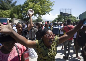 Demonstrators march demanding peace and security in La Plaine neighborhood of Port-au-Prince, Haiti, Friday, May 6, 2022. Escalating gang violence has prompted Haitians to organize protests to demand safer neighborhoods. (AP Photo/Odelyn Joseph)