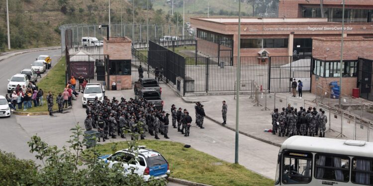 Oficiales de policía se reúnen afuera de la prisión de Turi en Cuenca, Ecuador, el 1 de septiembre de 2023. - Casi 60 guardias penitenciarios y policías fueron tomados como rehenes el viernes por reclusos en todo Ecuador. La autoridad penitenciaria de Ecuador, SNAI, anunció la noche del jueves que 50 guardias penitenciarios y siete policías se encontraban detenidos en seis cárceles diferentes, sin dar más detalles. La noticia llegó después de que dos coches bomba fueran detonados cerca de edificios pertenecientes a la autoridad penitenciaria en Quito la noche anterior, sin que nadie resultara herido. Tres explosiones de granadas sacudieron también la capital. (Foto de Fernando MACHADO/AFP)