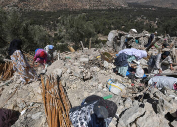 Residents salvage belongings from the rubble of Imoulas village in the Taroudant province, one of the most devastated in quake-hit Morocco, on September 11, 2023. - Moroccan rescuers supported by newly-arrived foreign teams on September 11 faced an intensifying race against time to dig out any survivors from the rubble of mountain villages, on the third day after the country's strongest-ever earthquake. (Photo by Fethi Belaid / AFP)