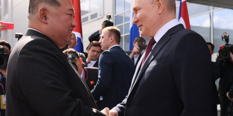 In this pool photo distributed by Sputnik agency, Russia's President Vladimir Putin (R) shakes hands with North Korea's leader Kim Jong Un (L) during their meeting at the Vostochny Cosmodrome in Amur region on September 13, 2023. - Russian President Vladimir Putin and North Korean leader Kim Jong Un both arrived at the Vostochny Cosmodrome in Russia's Far East, Russian news agencies reported on September 13, ahead of planned talks that could lead to a weapons deal. (Photo by Mikhail METZEL / POOL / AFP)