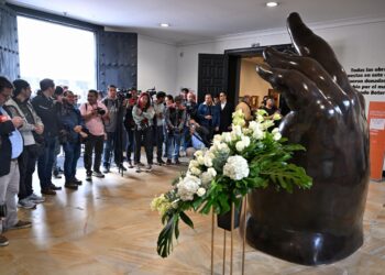 Visitantes observan la escultura de La Mano del artista colombiano Fernando Botero. Foto: AFP