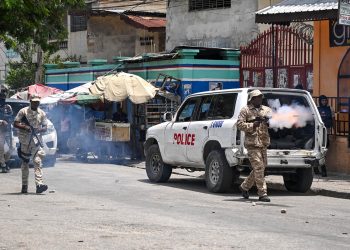 (FILES) Police officers throw tear gas to demonstrators during a protest against insecurity in Carrefour-Feuilles, a district of Port-au-Prince, Haiti, on August 14, 2023. - The UN Security Council will decide on October 2, 2023, whether to endorse an international force to back Haiti's police as they battle entrenched criminal gangs, according to a published agenda. For the past year, Haitian Prime Minister Ariel Henry and UN Secretary-General Antonio Guterres have called for such a force to address the country's spiraling security crisis. (Photo by Richard PIERRIN / AFP)