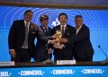 (L-R) Paraguayan Football Association President Robert Harrison, Uruguayan Football Association President Ignacio Alonso, Conmebol President Alejandro Dominguez and Argentine Football Association President Claudio Tapia hold a replica of the World Cup trophy after announcing in a press conference in Luque, Paraguay, on October 4, 2023, that the "inaugural matches" of the 2030 World Cup will be played in Uruguay, Argentina and Paraguay, as it emerged that the host country for the tournament will be shared between Spain, Portugal and Morocco. - Morocco, Portugal and Spain will be joint hosts for the 2030 World Cup but games will also be played in Uruguay, Argentina and Paraguay, FIFA announced on October 4. FIFA said in a statement that the matches in South America were part of the celebration of the centenary of the first World Cup in Uruguay. The statement said a "centenary ceremony" will be held "at the stadium where it all began", in Montevideo's Estadio Centenario in 1930. (Photo by Norberto DUARTE / AFP)