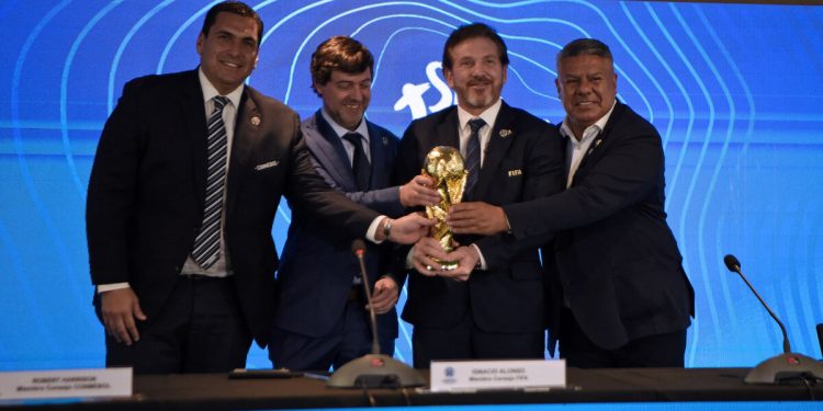 (L-R) Paraguayan Football Association President Robert Harrison, Uruguayan Football Association President Ignacio Alonso, Conmebol President Alejandro Dominguez and Argentine Football Association President Claudio Tapia hold a replica of the World Cup trophy after announcing in a press conference in Luque, Paraguay, on October 4, 2023, that the "inaugural matches" of the 2030 World Cup will be played in Uruguay, Argentina and Paraguay, as it emerged that the host country for the tournament will be shared between Spain, Portugal and Morocco. - Morocco, Portugal and Spain will be joint hosts for the 2030 World Cup but games will also be played in Uruguay, Argentina and Paraguay, FIFA announced on October 4. FIFA said in a statement that the matches in South America were part of the celebration of the centenary of the first World Cup in Uruguay. The statement said a "centenary ceremony" will be held "at the stadium where it all began", in Montevideo's Estadio Centenario in 1930. (Photo by Norberto DUARTE / AFP)
