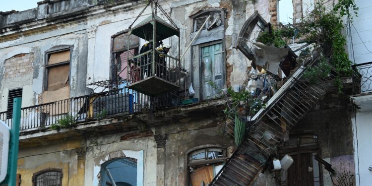 Rescuers work at an apartment block following a collapse, in Havana, on October 4, 2023. - At least one person has died, a firefighter, and two others are missing after the collapse at an apartment block where around fifty people were living, emergency services and state media announced on Wednesday. A woman, a member of a fire brigade who had come to the scene to secure the area after the first collapse, died during rescue operations in a second collapse, a firefighter told AFP on condition of anonymity. Another firefighter and a 76-year-old resident of the building are still missing, according to the same source, who said that only the façade of the building remained. (Photo by Yamil LAGE / AFP)