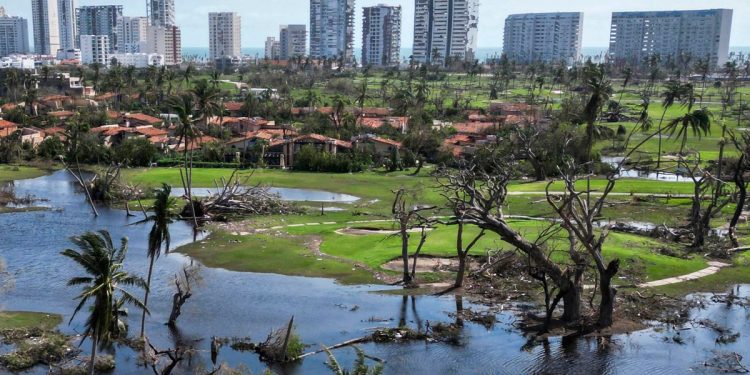 A golf course surrounded by debris is pictured in the aftermath of hurricane Otis at "Punta Diamante" in Acapulco, Guerrero State, Mexico, on October 27, 2023. - Airlines began to evacuate tourists from Mexico's beachside city of Acapulco on Friday after a scale-topping Category 5 hurricane left a trail of destruction and at least 27 people dead, authorities said on October 27, 2023. (Photo by RODRIGO OROPEZA / AFP)