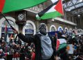 A protester waves a Palestinian flag as people take part in a sit-down protest inside Charing Cross station following the 'London Rally For Palestine' in, central London on November 4, 2023, as they call for a ceasefire in the conflict between Israel and Hamas. - Thousands of civilians, both Palestinians and Israelis, have died since October 7, 2023, after Palestinian Hamas militants based in the Gaza Strip entered southern Israel in an unprecedented attack triggering a war declared by Israel on Hamas with retaliatory bombings on Gaza. (Photo by JUSTIN TALLIS / AFP)