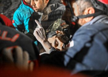 El hombre sirio Faez Ghanam salvado por trabajadores de rescate de debajo de los escombros después de 210 horas, es llevado a una ambulancia en Hatay, sureste de Turquía, el 14 de febrero de 2023, una semana después de que un terremoto mortal azotara partes de Turquía y Siria. (Foto de BULENT KILIC / AFP)