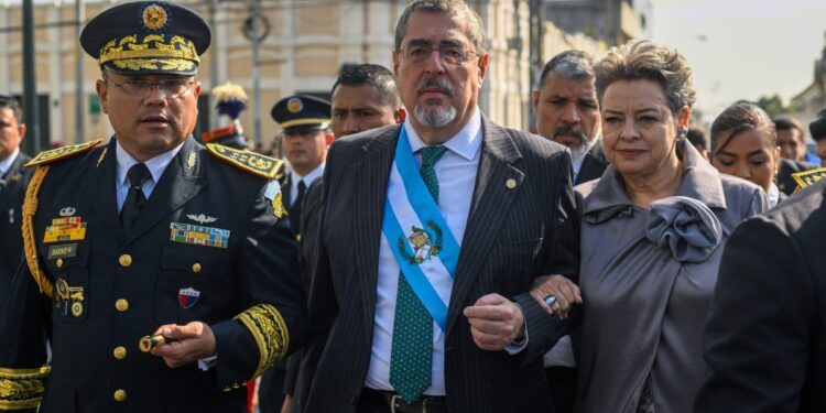 Guatemala's President Bernardo Arevalo (C) and his wife Lucrecia Peinado walk with Defence Minister Henry Saenz as they arrive for the ceremony to recognize him as the Commander in Chief of the Armed Forces, outside the National Palace of Culture in Guatemala City, on January 15, 2024. - Guatemala's new President Bernardo Arevalo promised early on Monday to fight corruption and stand firm against global authoritarianism, in his first speech after being sworn in. (Photo by Johan ORDONEZ / AFP)