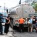 People collect water from trucks of the Costa Rican Institute of Aqueducts and Sewers (AyA) in San Jose, Costa Rica on January 26, 2024. - More than 100,000 people were affected by contamination with "a hydrocarbon" in the drinking water network in various neighborhoods of the capital of Costa Rica, the Minister of Health, Mary Munive, reported this Friday. (Photo by Ezequiel BECERRA / AFP)