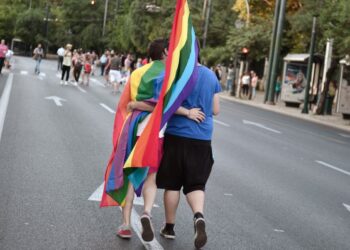(FILES) Participants hug and kiss in Athens during the annual Gay Pride parade on June 14, 2014.  AFP PHOTO / LOUISA GOULIAMAKI - A historic bill legalising same-sex marriage and adoption will be put to a vote, on February 15, 2024. The Church of Greece is "totally opposed" to the reform. However, the bill is sure to pass with the support of the main opposition Syriza party, whose leader Stefanos Kasselakis is gay, the socialist Pasok party and other smaller parties. (Photo by LOUISA GOULIAMAKI / AFP)