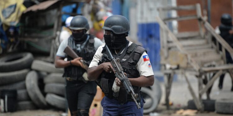 Police officers patrol a neighborhood amid gang-related violence in downtown Port-au-Prince on April 25, 2023. Between April 14 and 19, clashes between rival gangs left nearly 70 people dead, including 18 women and at least two children, according to a United Nations statement released April 24. (Photo by RICHARD PIERRIN / AFP)