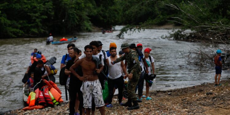 Migrants are pictured upon arrival at the Migrant Reception Station in Lajas Blancas, Darien Province, Panama, on October 6, 2023. The Darien jungle, on the border with Colombia, has become a corridor for migrants from South America trying to reach the United States through Central America and Mexico. (Photo by Roberto CISNEROS / AFP)