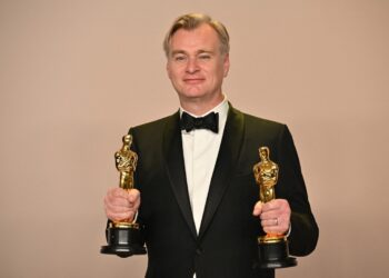 British director Christopher Nolan poses in the press room with the Oscars for Best Director and Best Picture for "Oppenheimer" during the 96th Annual Academy Awards at the Dolby Theatre in Hollywood, California on March 10, 2024. (Photo by Robyn BECK / AFP)