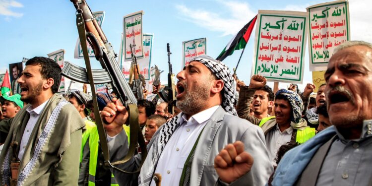 Demonstrators chant slogans and gather with assault rifles during a pro-Palestinian and anti-Israel rally outside al-Saleh mosque in the Huthi-held capital Sanaa on March 29, 2024 amid the ongoing conflict in the Gaza Strip between Israel and the Palestinian militant group Hamas. (Photo by MOHAMMED HUWAIS / AFP)