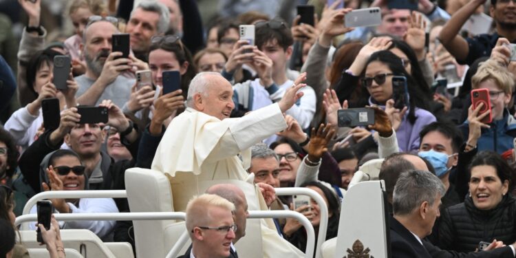 Pope Francis waves to the crowd from the popemobile after the Easter Mass as part of the Holy Week celebrations, at St Peter's square in the Vatican on March 31, 2024. (Photo by Tiziana FABI / AFP)