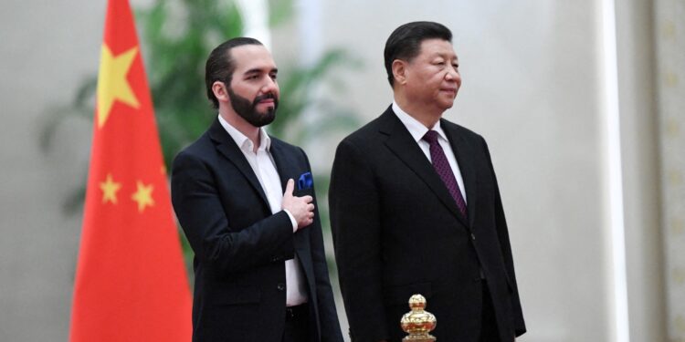 China's President Xi Jinping (R) and El Salvador's President Nayib Bukele (L) stand before they inspect an honour guard during a welcoming ceremony at the Great Hall of the People in Beijing on December 3, 2019. (Photo by Noel Celis / AFP)