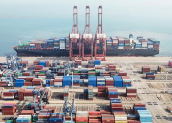 An aerial view shows shipping containers stacked at a port in Lianyungang, in eastern China's Jiangsu province on April 12, 2024. - Chinese exports plunged more than expected in March, official figures showed on April 12, as the world's second-largest economy struggles to sustain its post-pandemic recovery. (Photo by AFP) / China OUT / CHINA OUT