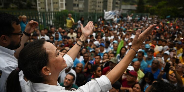 Venezuelan opposition leader Maria Corina Machado greets supporters during a rally in San Antonio de los Altos, Miranda state, Venezuela on April 17, 2024. (Photo by Juan BARRETO / AFP)