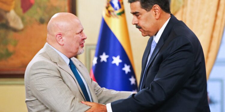 This handout picture released by the Venezuelan Presidency shows Venezuela's President Nicolas Maduro (R) shaking hands with International Criminal Court (ICC) Prosecutor Karim Khan (L) during a television program at the Presidencial Palace in Caracas, on April 23, 2024. - Maduro announced on Tuesday the return to the country of the office of the United Nations High Commissioner for Human Rights, expelled in February after expressing concern over the arrest of a humanitarian activist. (Photo by Zurimar Campos / Venezuelan Presidency / AFP) / RESTRICTED TO EDITORIAL USE - MANDATORY CREDIT "AFP PHOTO / VENEZUELAN PRESIDENCY / ZURIMAR CAMPOS" - NO MARKETING NO ADVERTISING CAMPAIGNS - DISTRIBUTED AS A SERVICE TO CLIENTS
