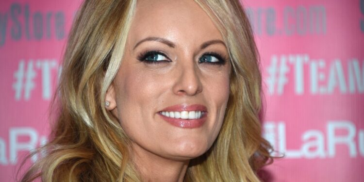 (FILES) Adult film star Stormy Daniels poses and signs autographs at Chi Chi Larue's adult entertainment store May 23, 2018 in West Hollywood, California. - Donald Trump goes on trial on April 15, 2024 for allegedly covering up hush money payments to hide affairs ahead of the 2016 presidential election which propelled him into the White House. (Photo by Robyn Beck / AFP)
